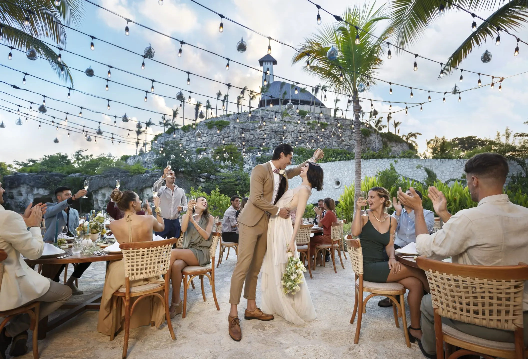 Wedding reception under string lights at Hotel Xcaret Arte, Riviera Maya