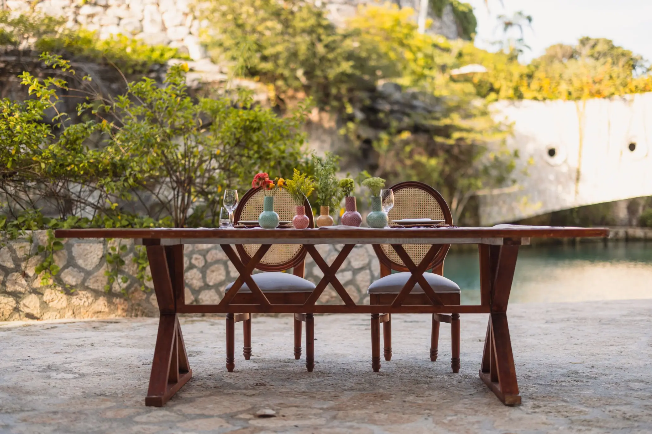 Private dinner table set by a natural lagoon at Hotel Xcaret Arte, Riviera Maya