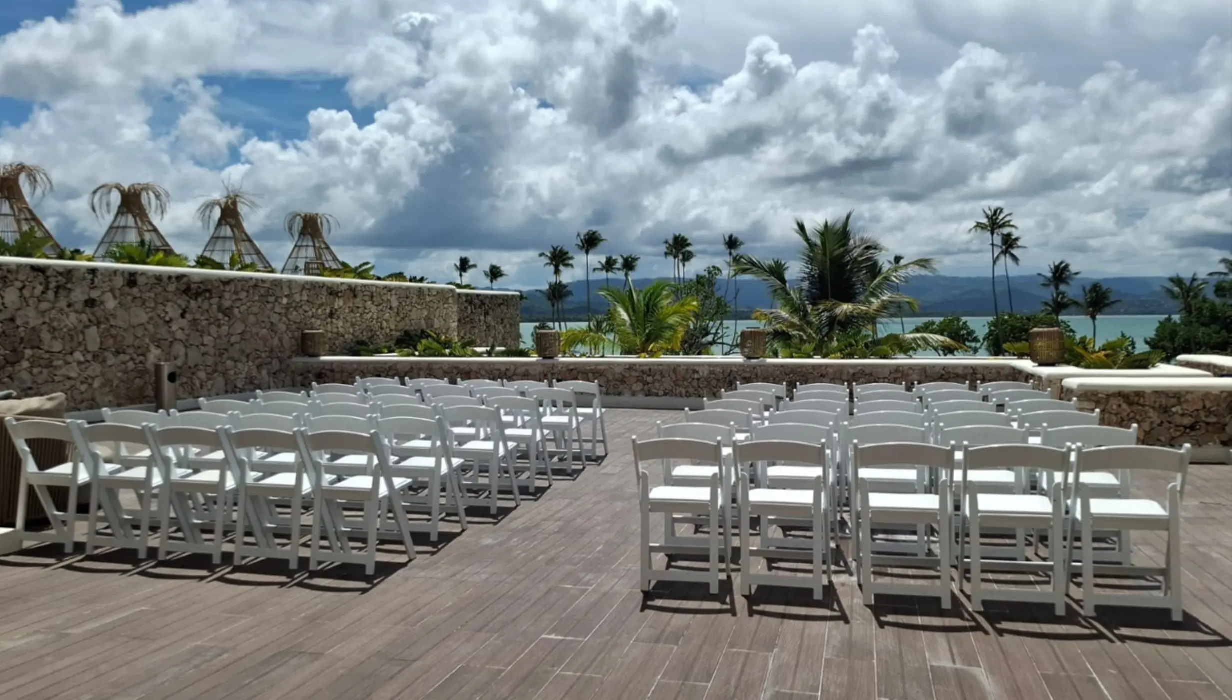 Azure rooftop wedding ceremony setup with white chairs at Zemi Miches, Punta Cana