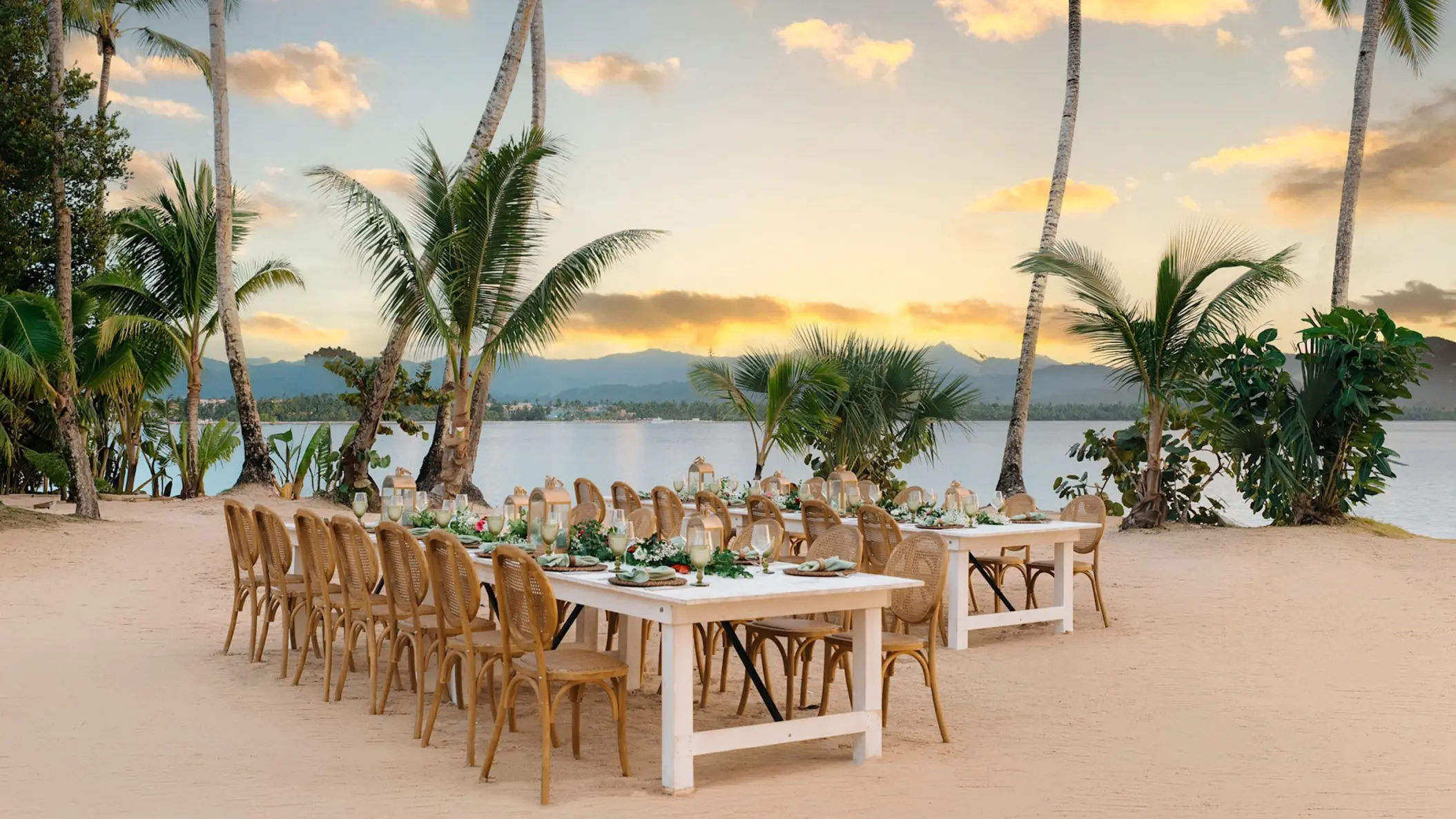 Beachfront wedding reception setup with wooden tables at Zemi Miches, Punta Cana
