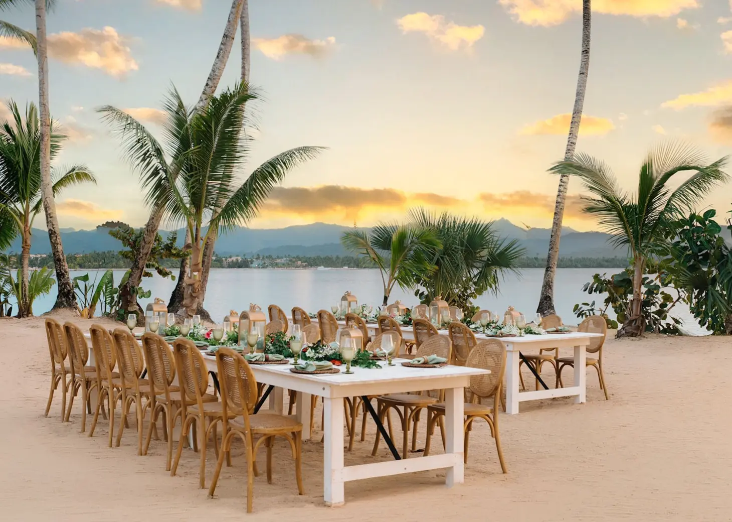 Beachfront wedding reception setup with wooden tables at Zemi Miches, Punta Cana