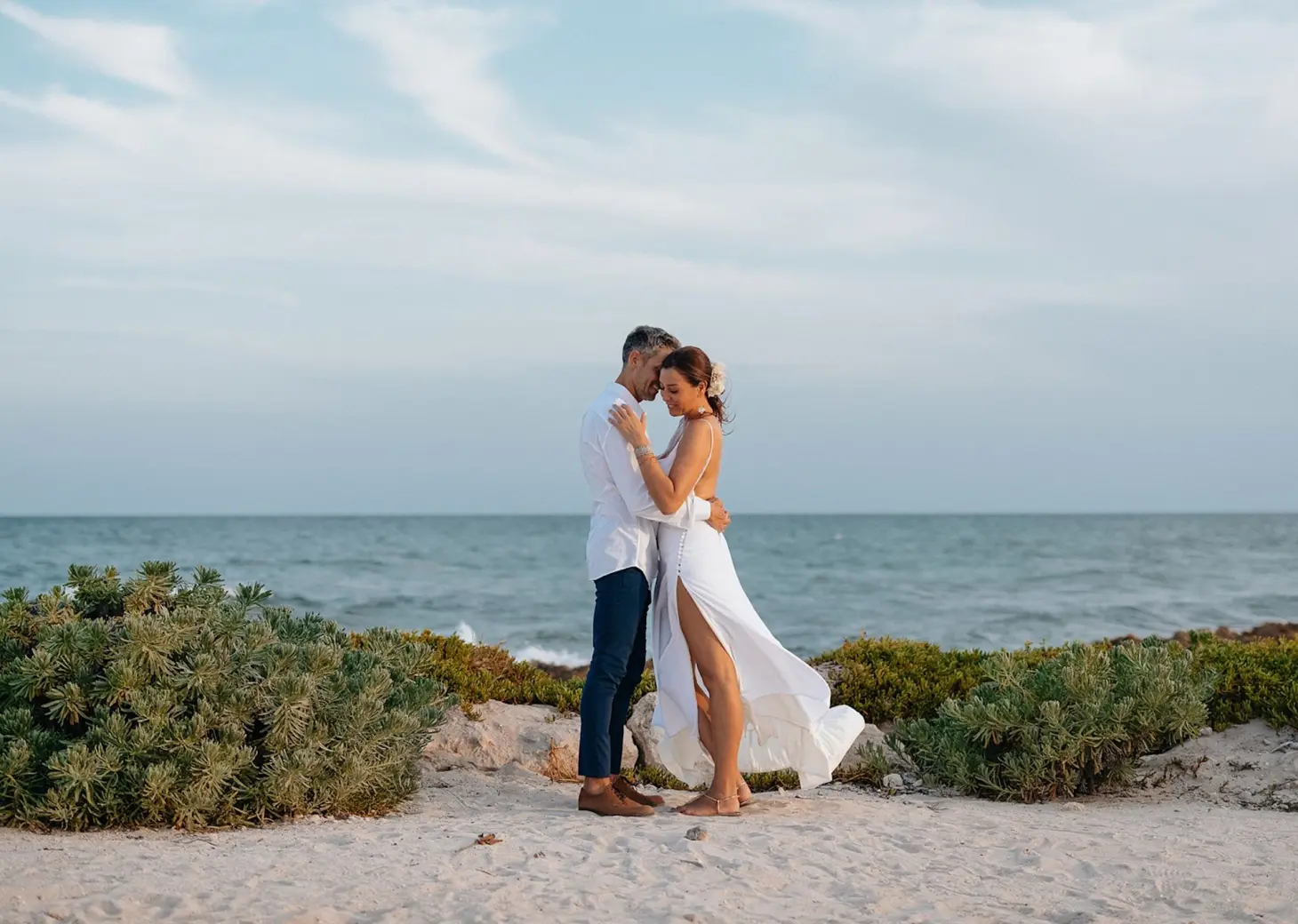 Bride and groom embracing on a beach at Zemi Miches, Punta Cana