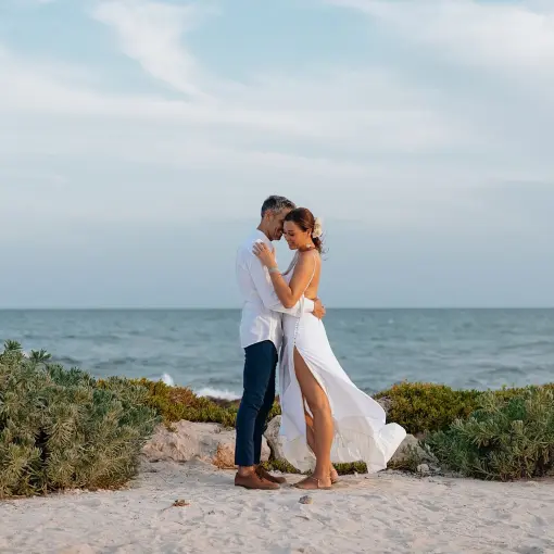 Bride and groom embracing on a beach at Zemi Miches, Punta Cana