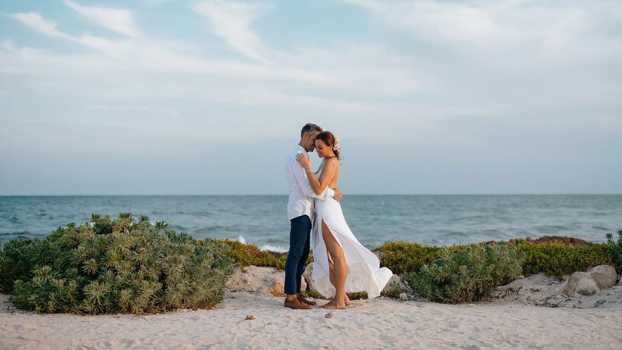 Bride and groom embracing on a beach at Zemi Miches, Punta Cana
