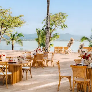 Beachfront wedding reception tables with floral centerpieces at Zemi Miches, Punta Cana