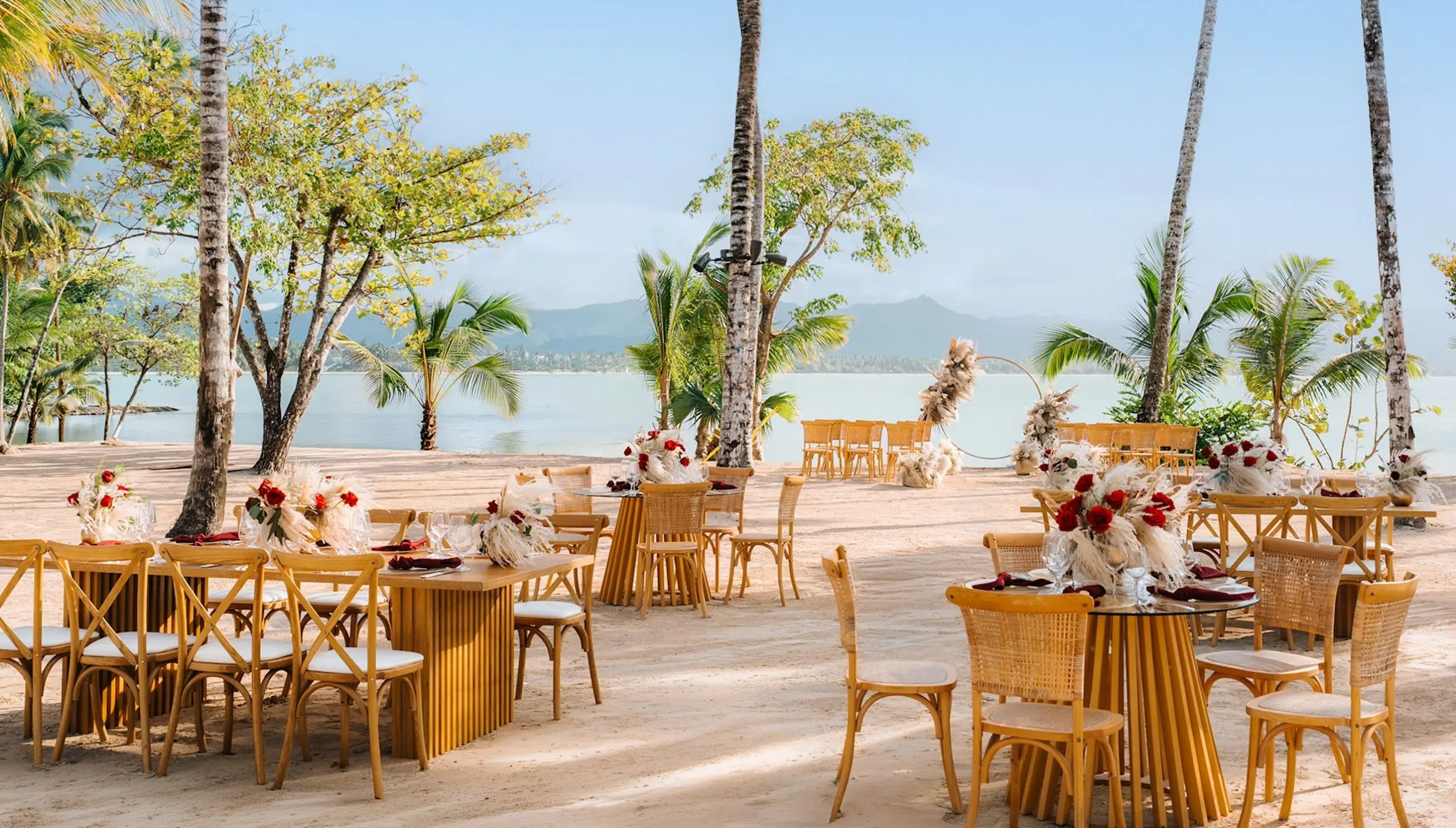 Beachfront wedding reception tables with floral centerpieces at Zemi Miches, Punta Cana