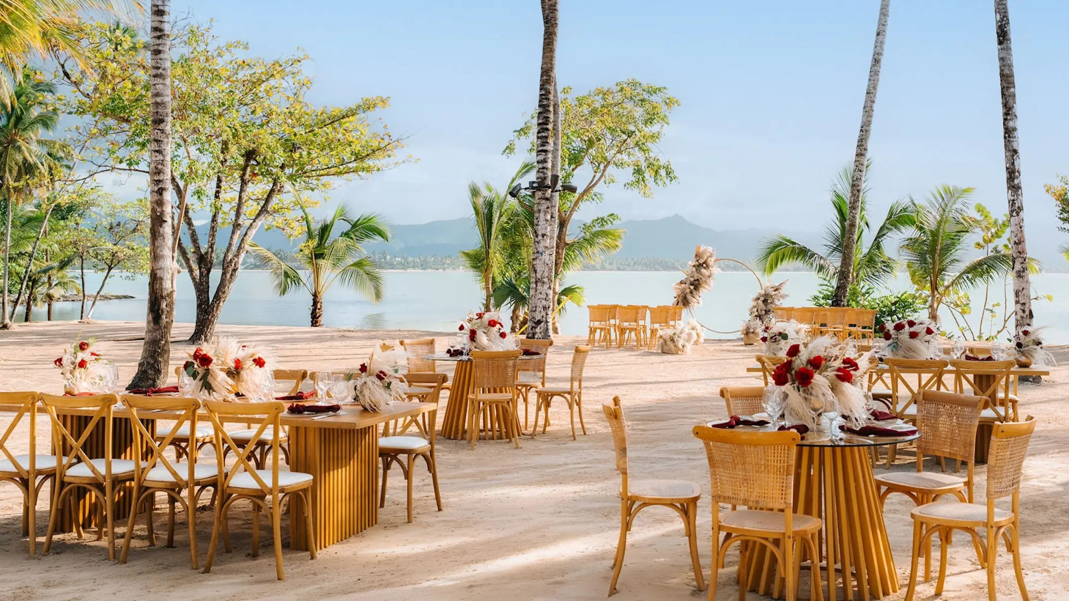 Beachfront wedding reception tables with floral centerpieces at Zemi Miches, Punta Cana