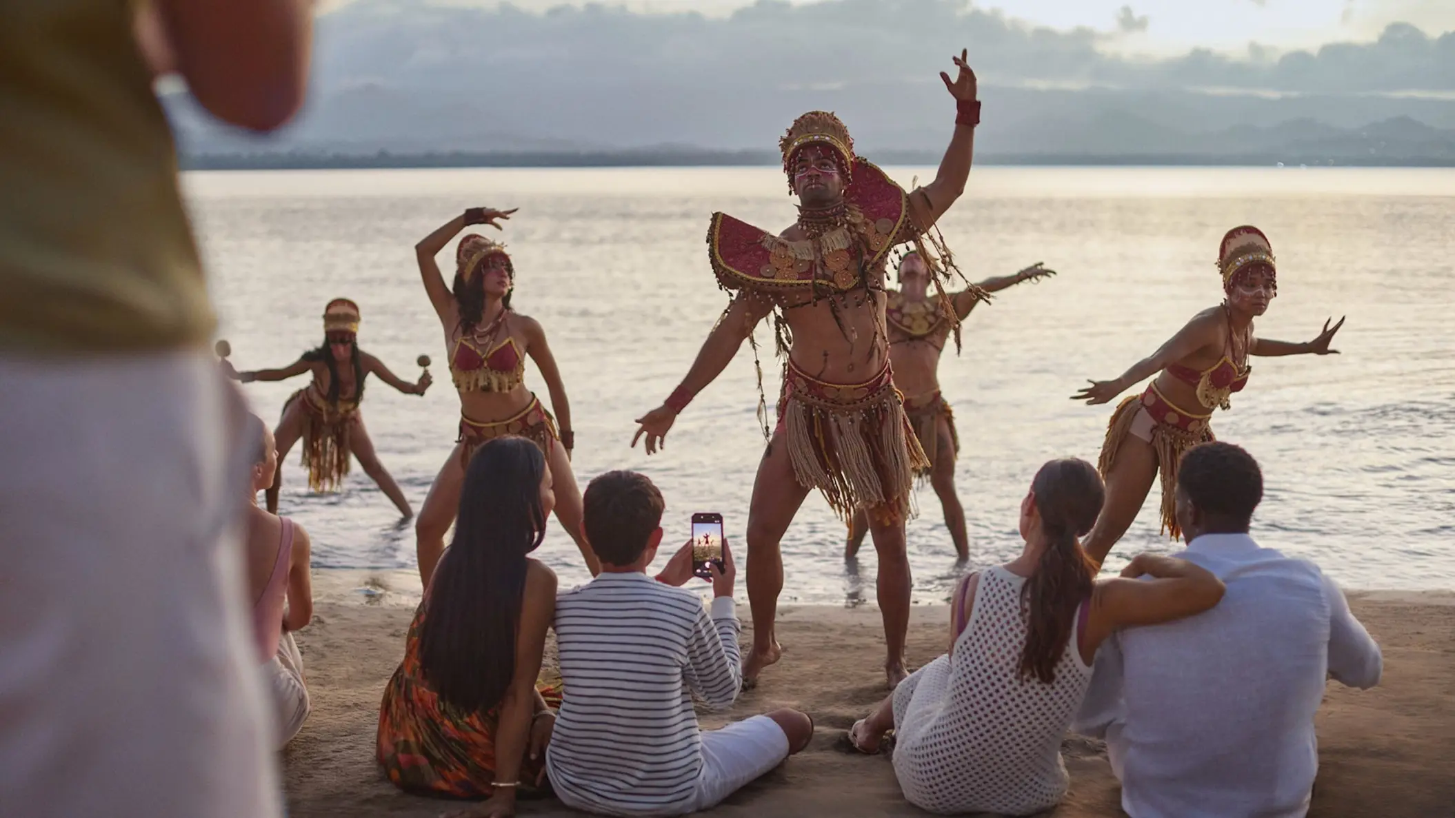 Dancers in traditional costumes performing for guests on the beach at Zemi Miches, Punta Cana
