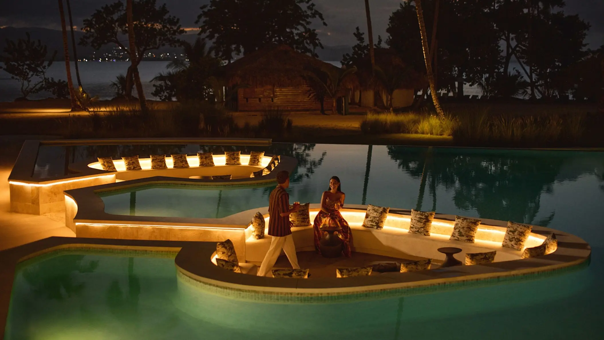 Sunken pool lounge with glowing lights at night at Zemi Miches, Punta Cana