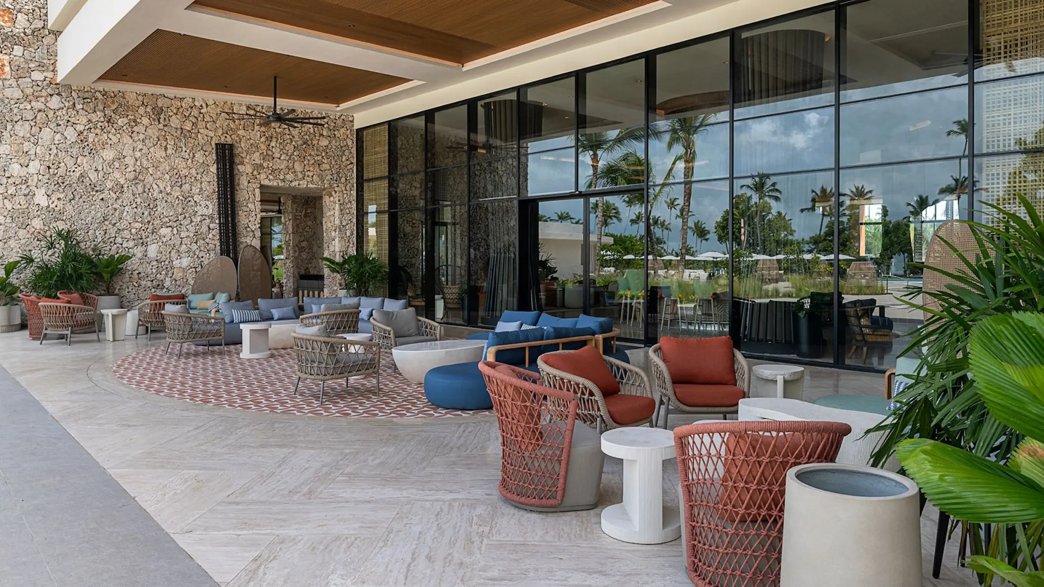 Zemi Miches lobby terrace with outdoor lounge seating and glass walls, Punta Cana