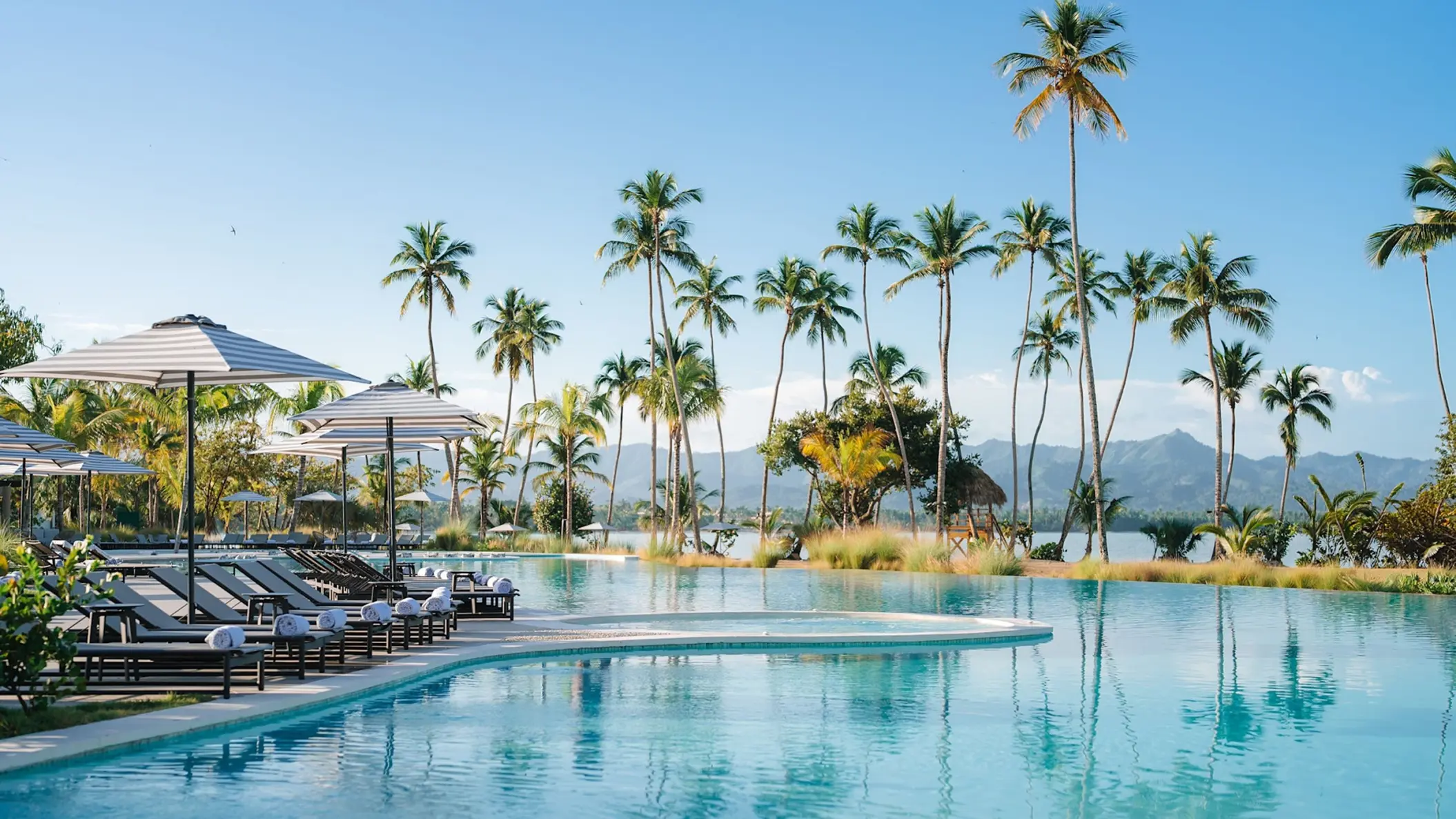 Zemi Miches infinity pool with lounge chairs and palm trees, Punta Cana