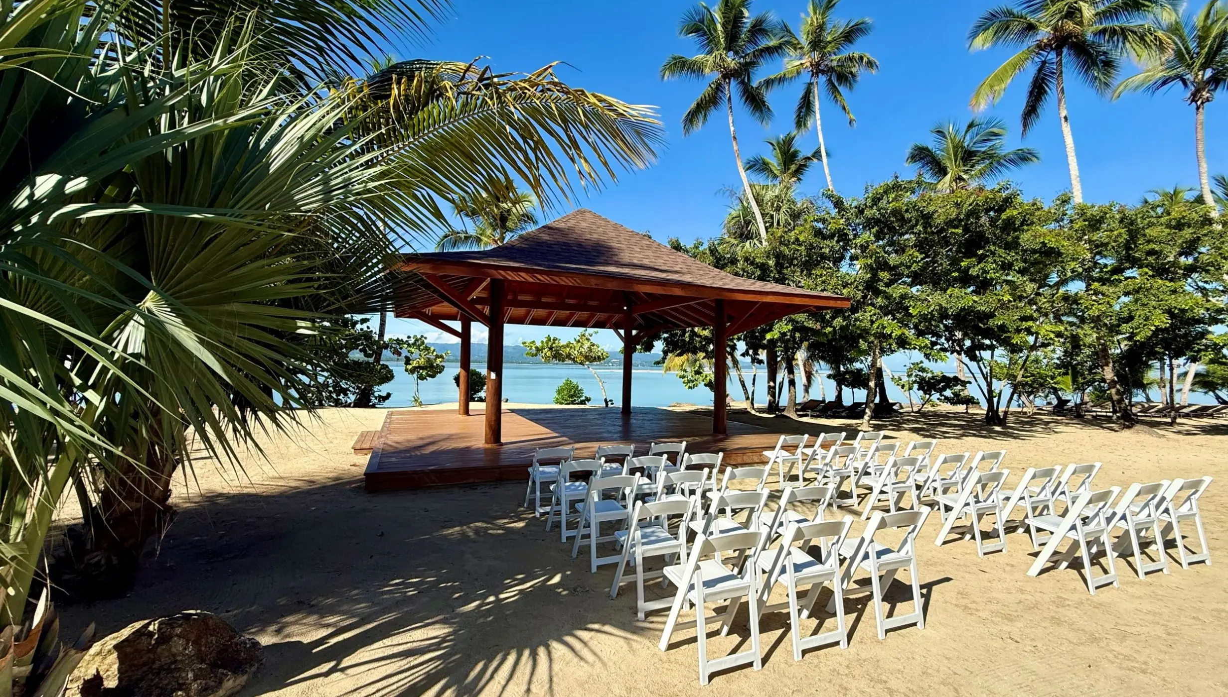 Beachfront wedding ceremony gazebo with white chairs at Zemi Miches, Punta Cana