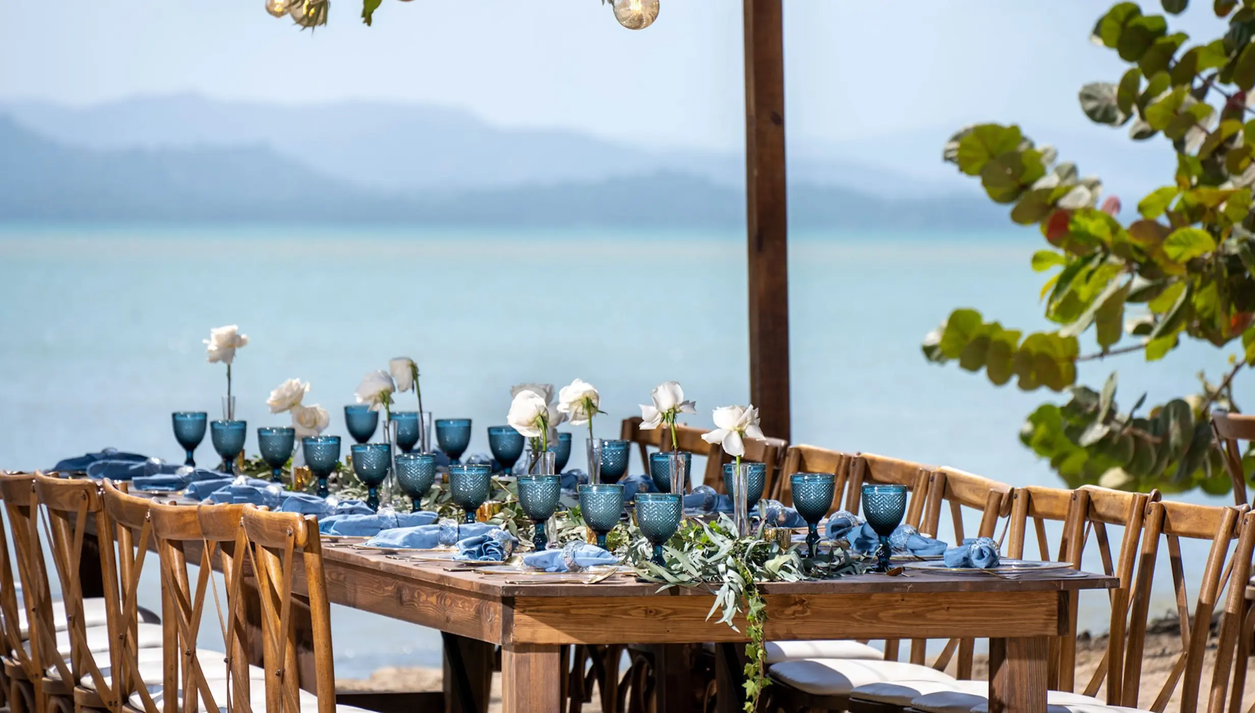 Beachfront wedding reception setup with blue glassware at Zemi Miches, Punta Cana
