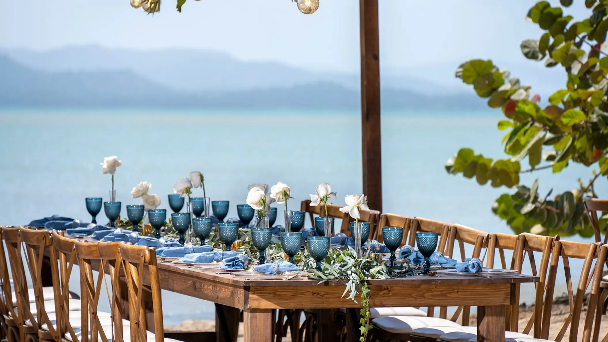 Beachfront wedding reception setup with blue glassware at Zemi Miches, Punta Cana