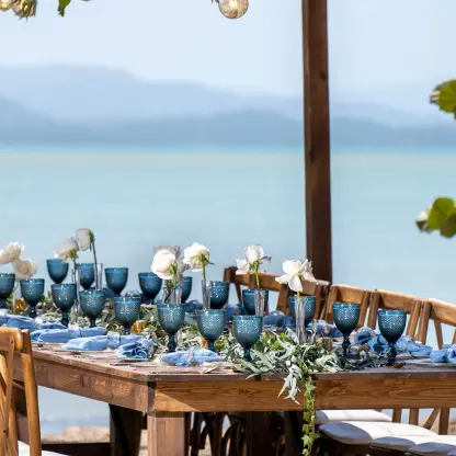 Beachfront wedding reception setup with blue glassware at Zemi Miches, Punta Cana