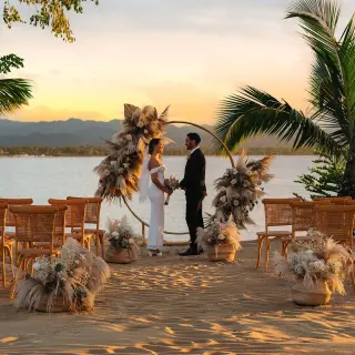 Beachfront wedding ceremony with a circular floral arch at Zemi Miches, Punta Cana