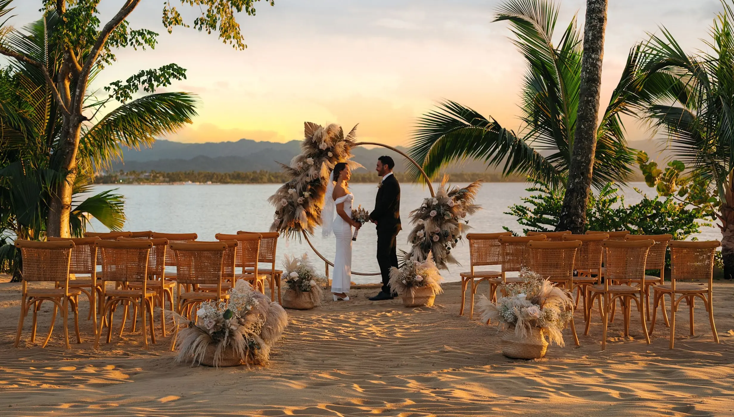 Beachfront wedding ceremony with a circular floral arch at Zemi Miches, Punta Cana
