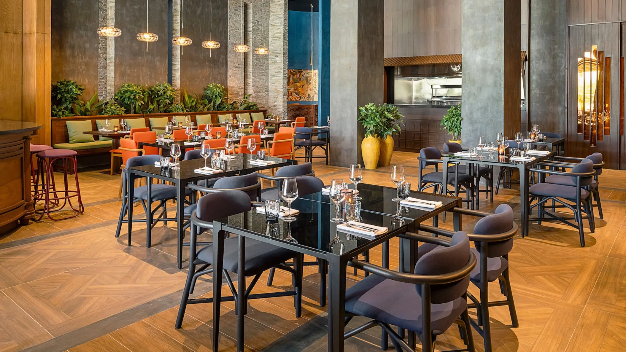 Modern restaurant dining room with black tables and blue chairs at Zemi Miches, Punta Cana