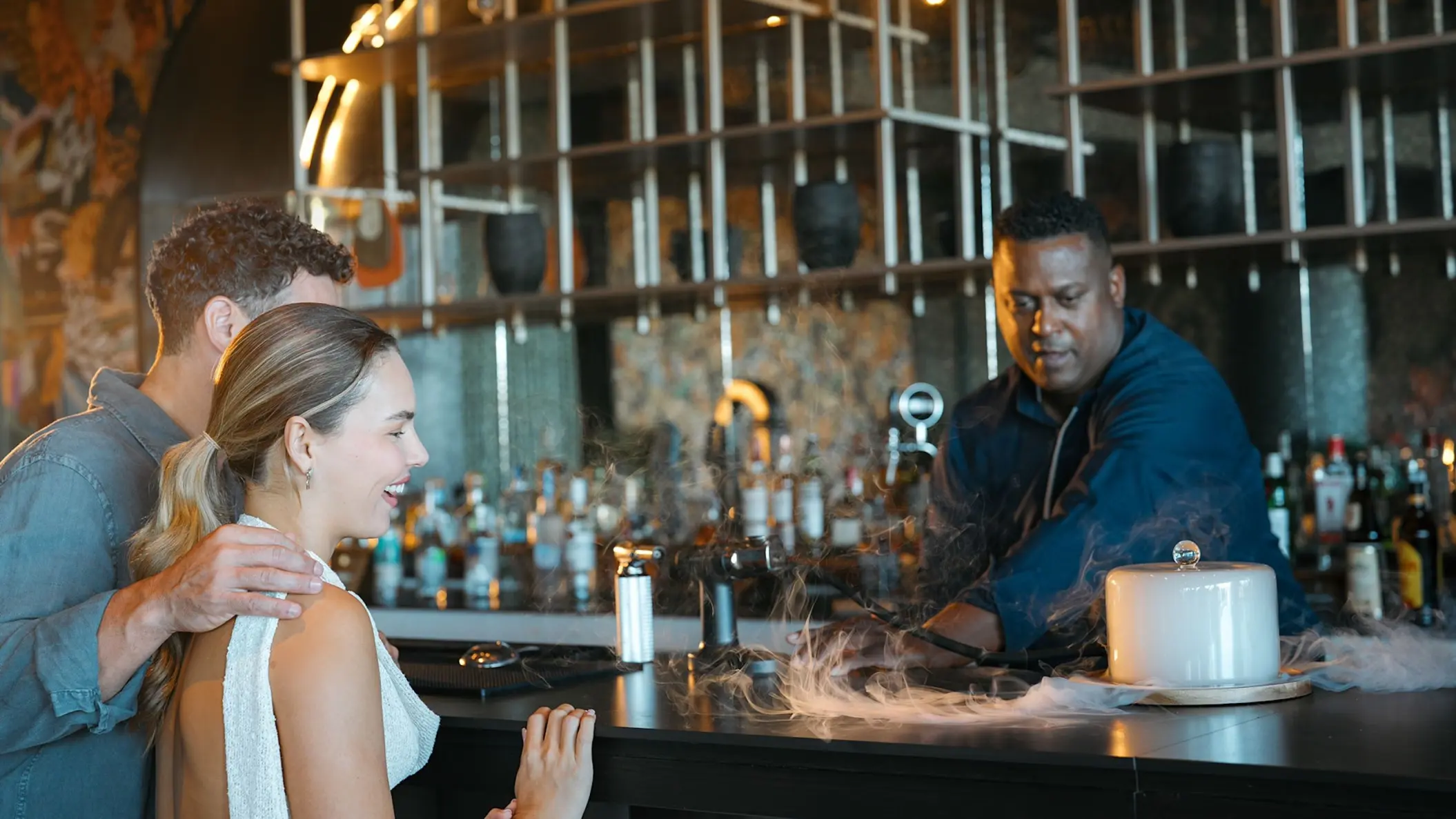 Bartender preparing a cocktail for a couple at the Caicu Bar in Zemi Miches, Punta Cana