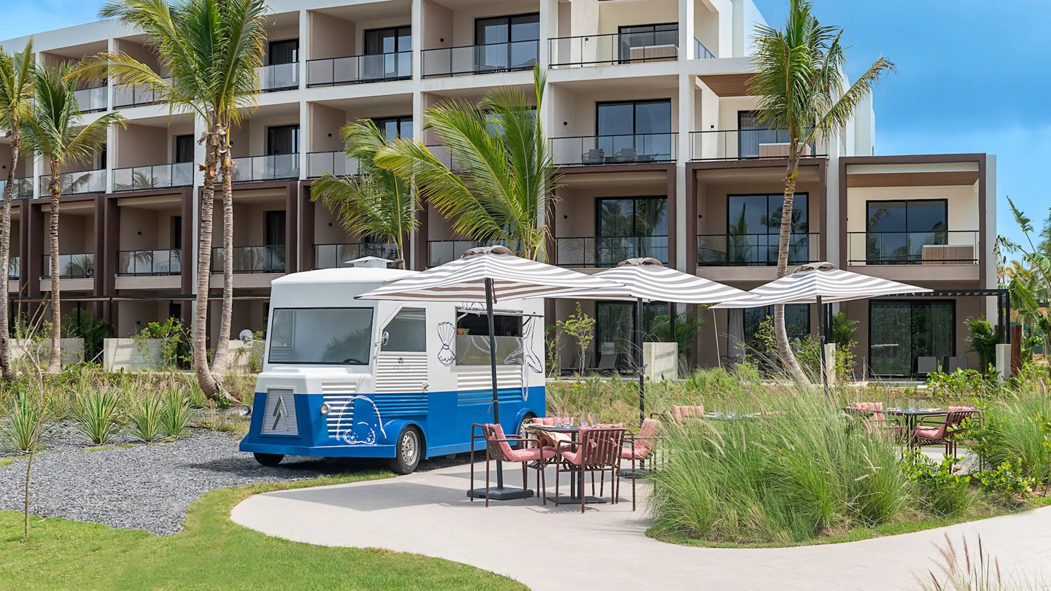 Blue and white food truck with outdoor seating at Zemi Miches, Punta Cana