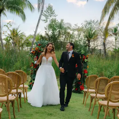 Bride and groom walking down the aisle at a garden wedding ceremony at Zemi Miches, Punta Cana
