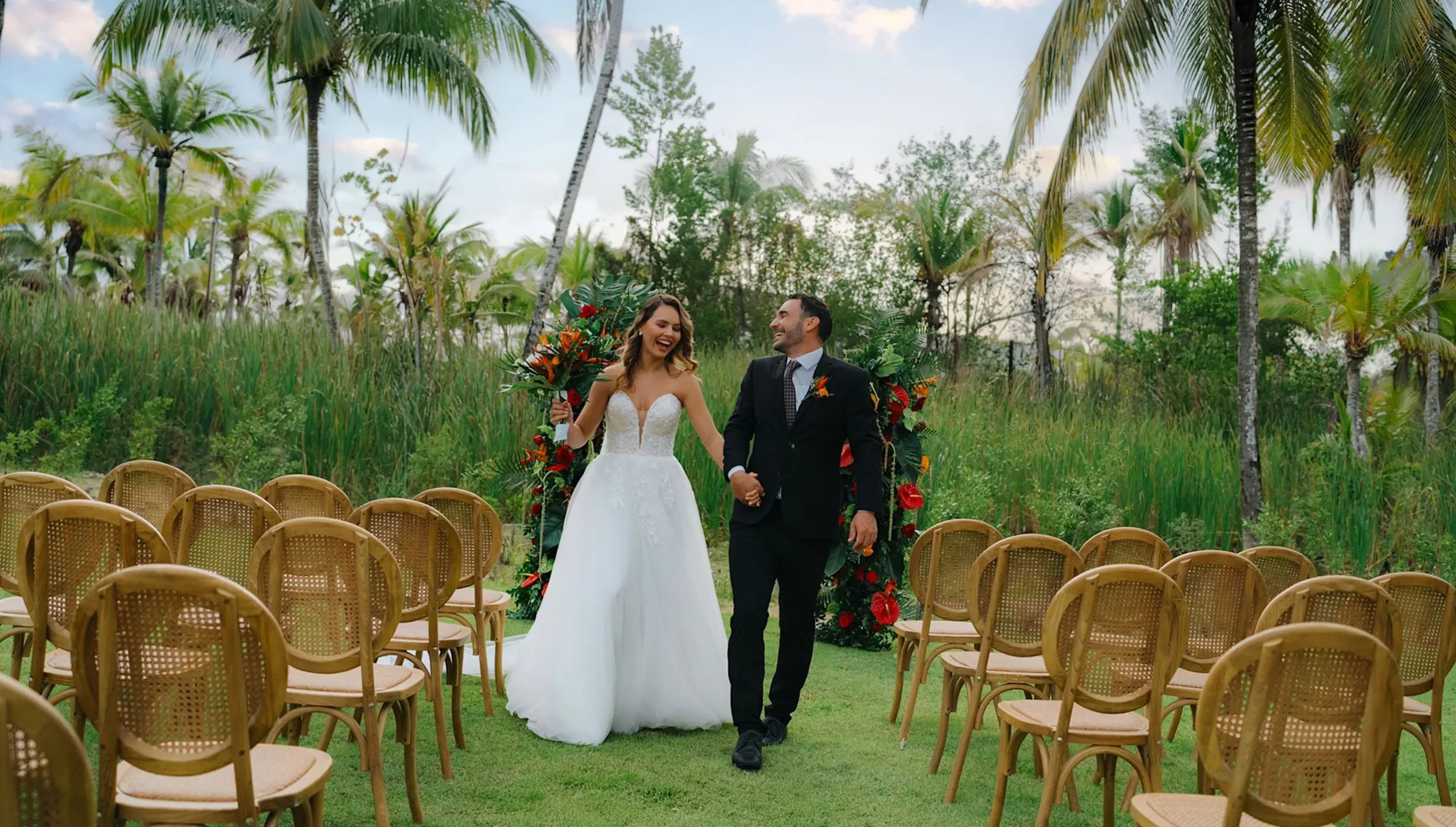 Bride and groom walking down the aisle at a garden wedding ceremony at Zemi Miches, Punta Cana