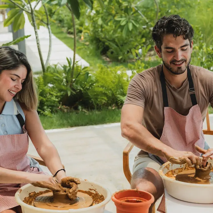 Couple participating in a clay pottery activity at Zemi Miches, Punta Cana