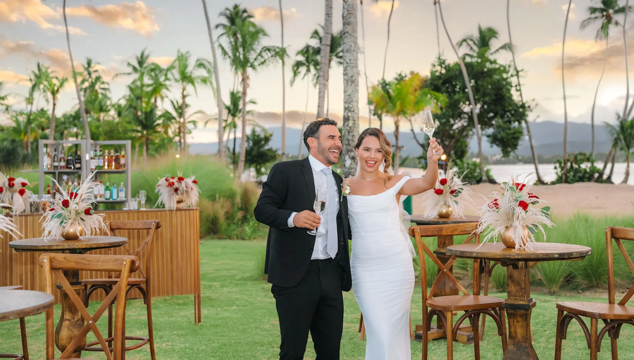 Couple toasting at a garden cocktail hour during their wedding at Zemi Miches, Punta Cana