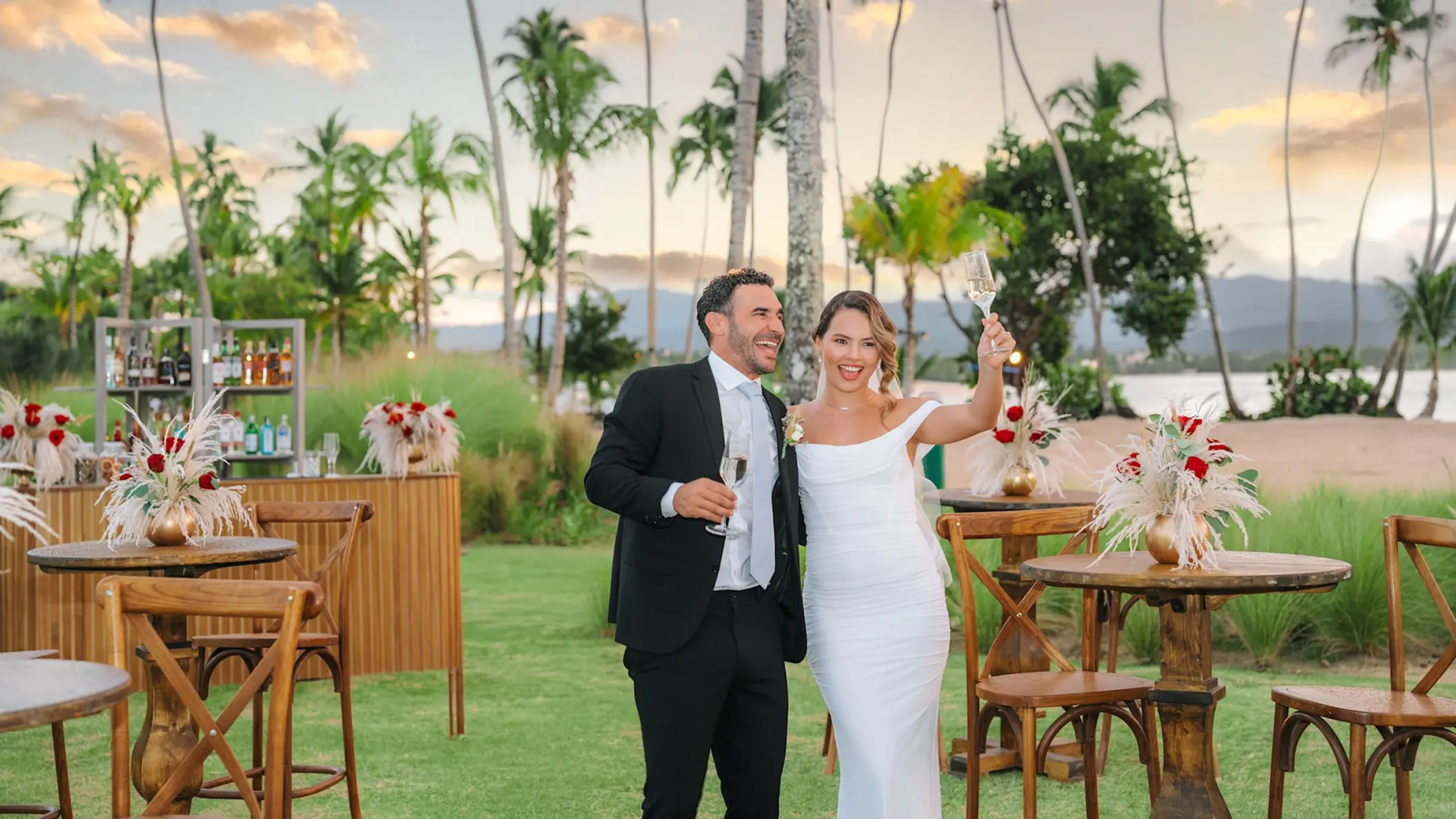 Couple toasting at a garden cocktail hour during their wedding at Zemi Miches, Punta Cana