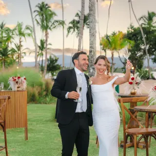 Couple toasting at a garden cocktail hour during their wedding at Zemi Miches, Punta Cana