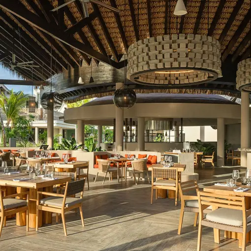 Yuca restaurant dining area under a thatched roof at Zemi Miches, Punta Cana