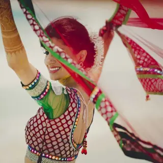 South Asian bride dancing on the beach during a wedding at Zoetry Agua Punta Cana