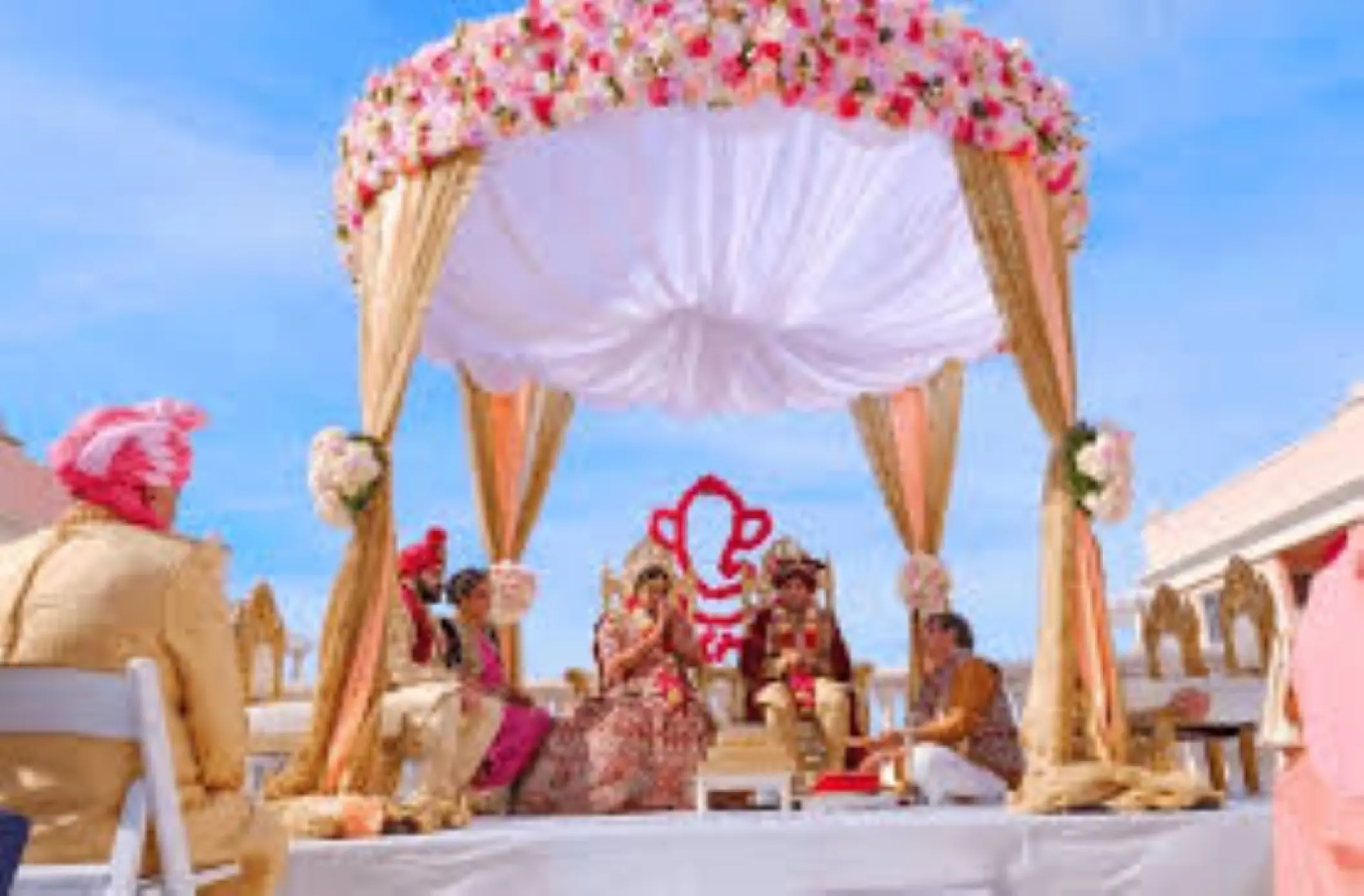 South Asian wedding ceremony under a floral mandap at Zoetry Agua, Punta Cana