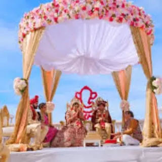 South Asian wedding ceremony under a floral mandap at Zoetry Agua, Punta Cana