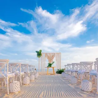 Beachfront wedding ceremony with white cross-back chairs at Zoetry Casa del Mar, Cabo San Lucas