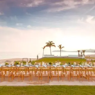Long wooden wedding reception table on a terrace at Zoetry Casa del Mar, Cabo San Lucas