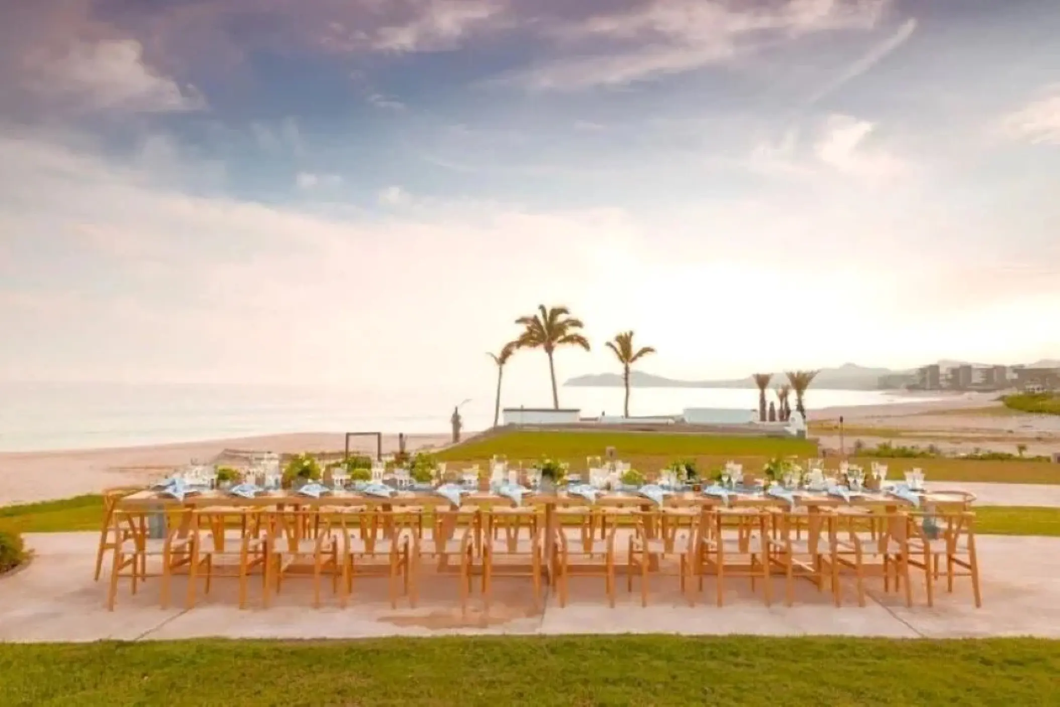 Long wooden wedding reception table on a terrace at Zoetry Casa del Mar, Cabo San Lucas