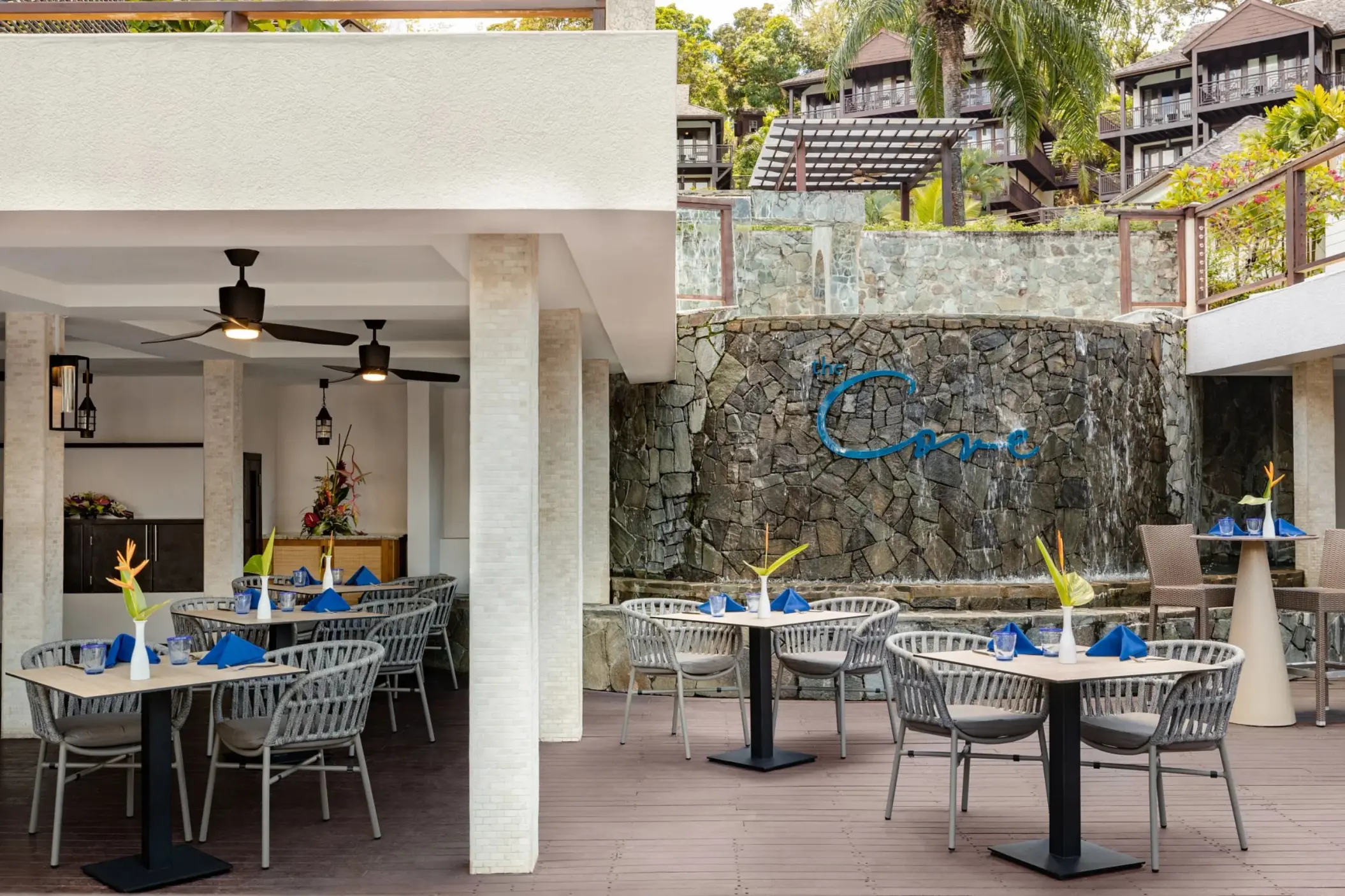 The Cove restaurant outdoor dining area with a stone waterfall at Zoetry Marigot Bay, Castries