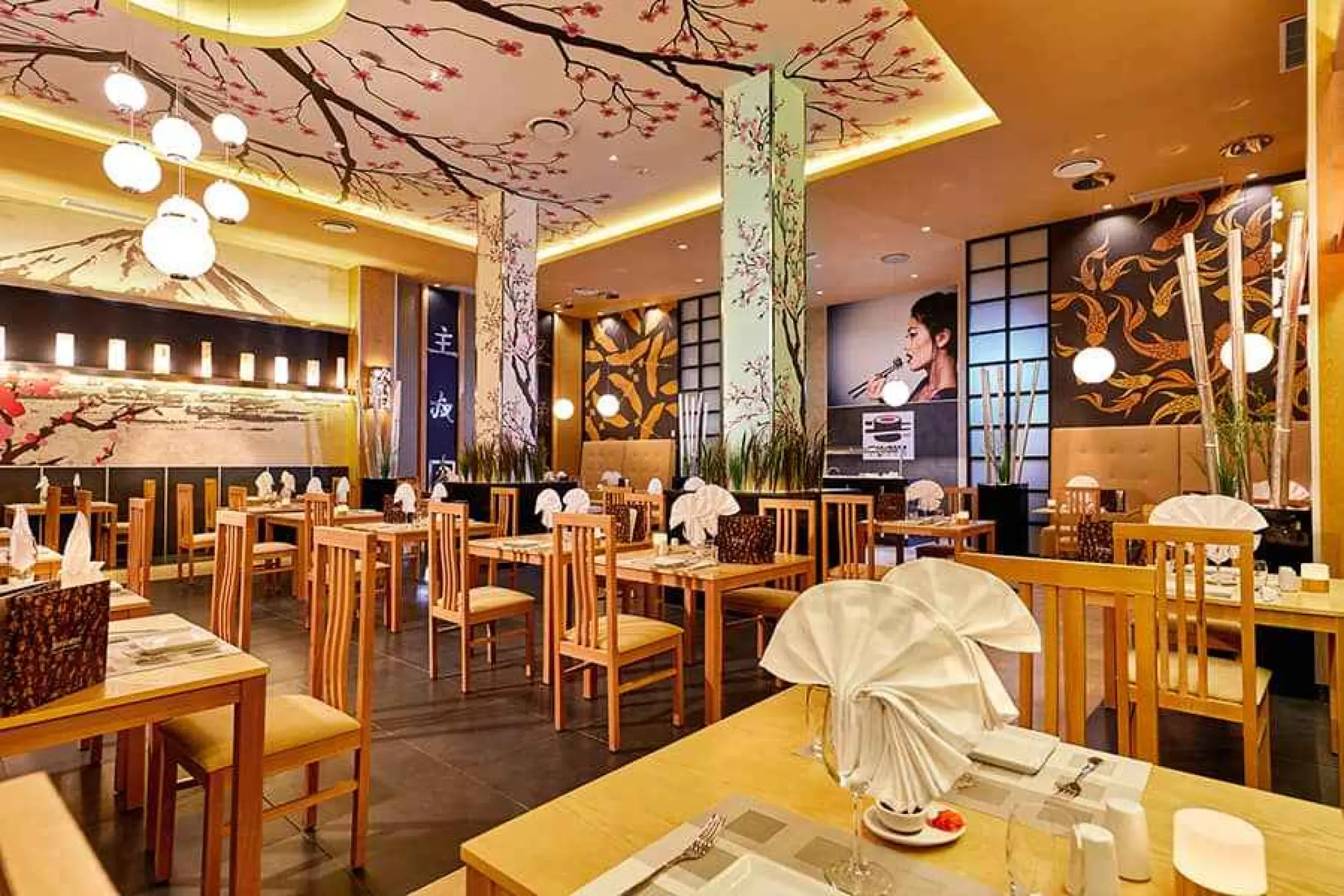 Japanese restaurant interior with floral ceiling murals and wooden seating at Riu Palace Costa Mujeres, Cancun