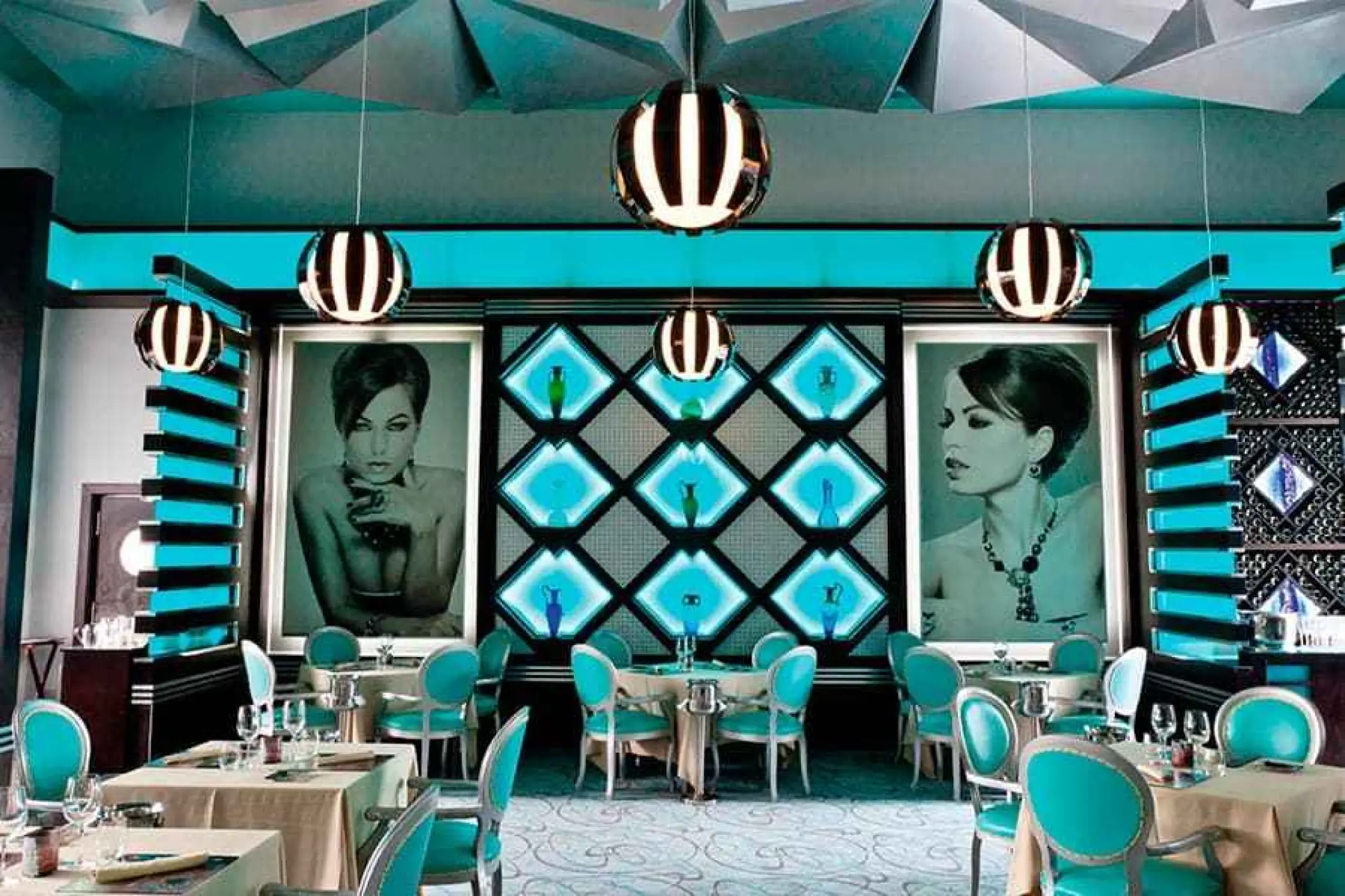 Krystal restaurant interior with turquoise chairs and modern art at Riu Palace Mexico, Playa Del Carmen