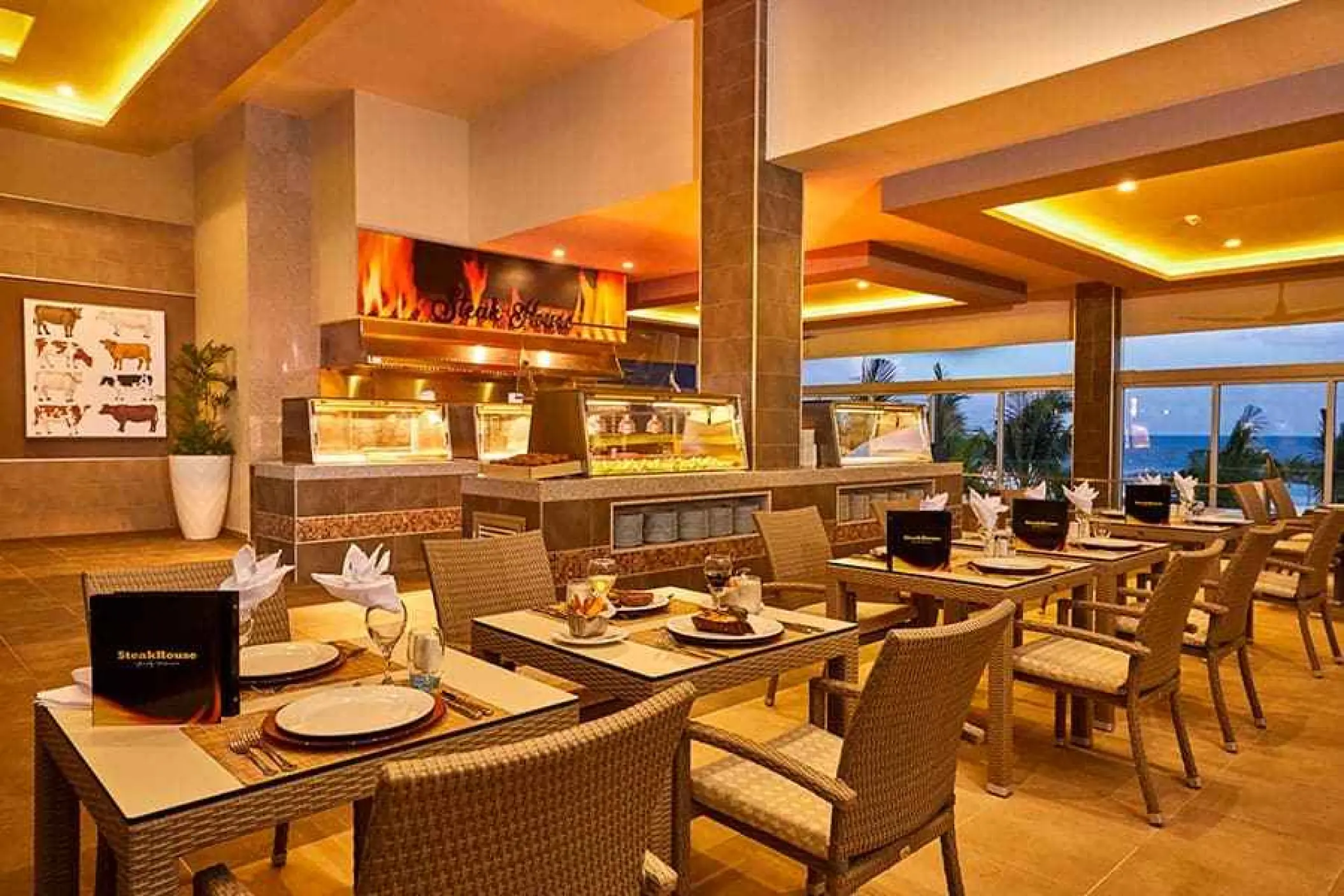 Steakhouse dining room with set tables and buffet area at Riu Palace Costa Mujeres, Cancun