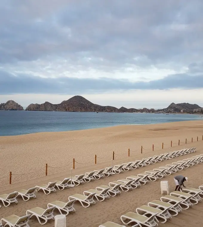 Beachfront lounge chairs at Riu Palace Baja California overlooking the ocean and mountains, Cabo San Lucas