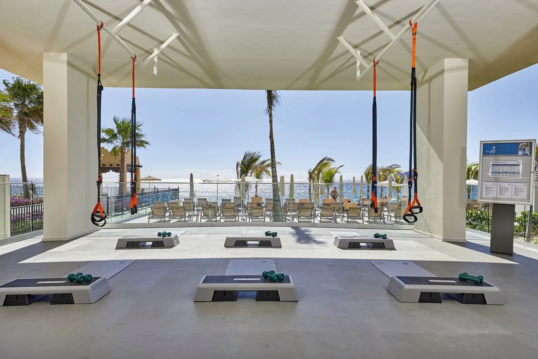 Outdoor fitness area with TRX straps and step platforms at Riu Palace Baja California, Cabo San Lucas