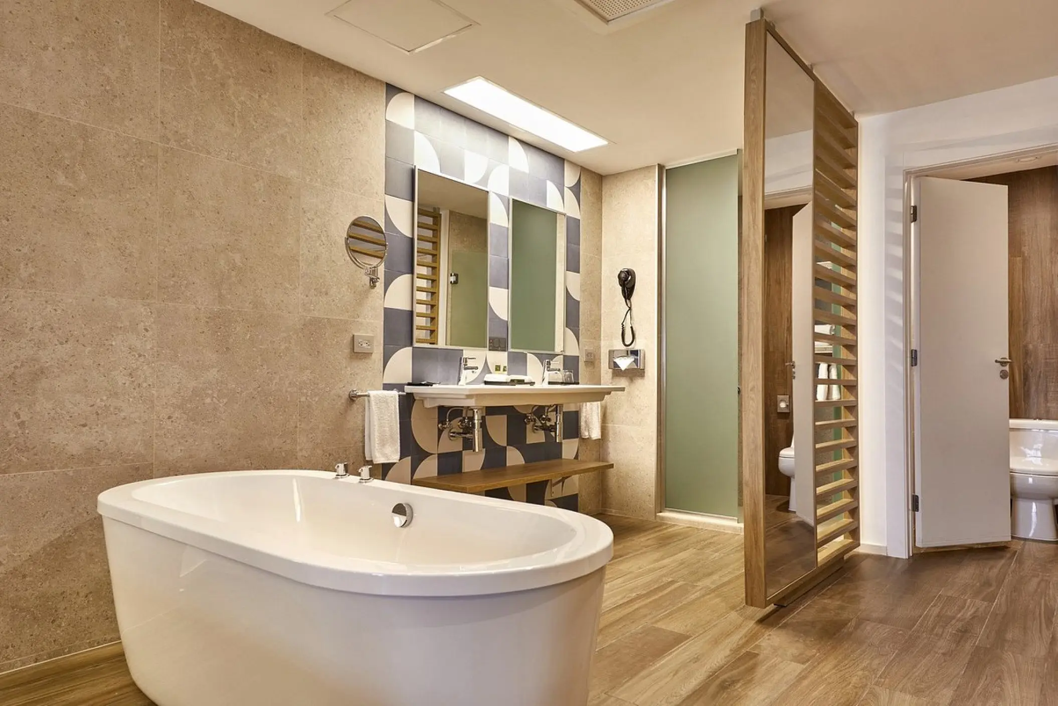 Junior Suite bathroom with a soaking tub and double vanity at Riu Palace Baja California, Cabo San Lucas