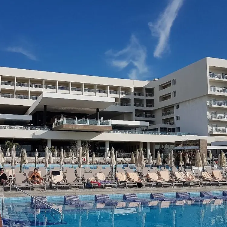Riu Palace Baja California modern facade and pool deck with sun loungers, Cabo San Lucas