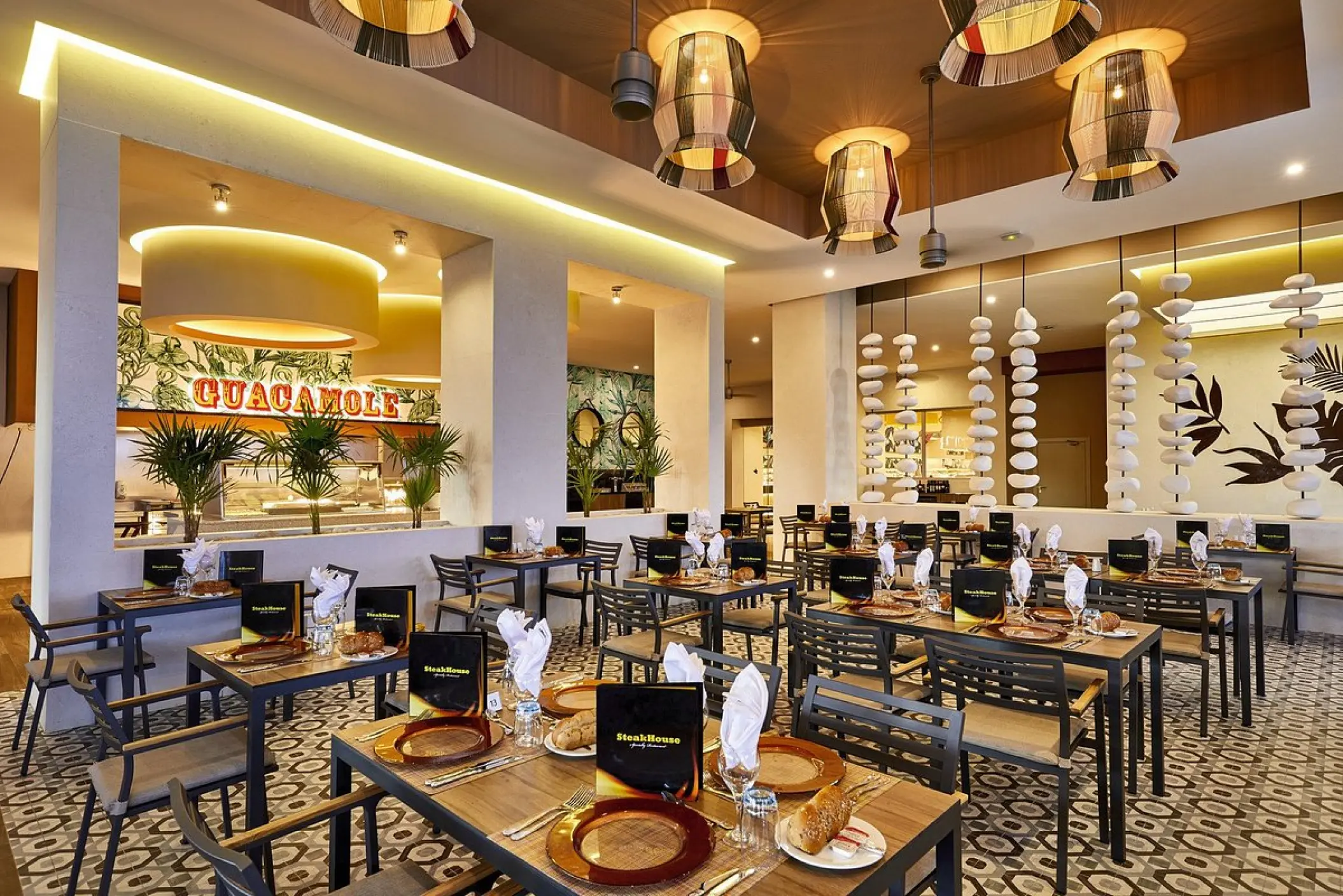 Theme restaurant dining room with set tables and patterned floors at Riu Palace Baja California, Cabo San Lucas