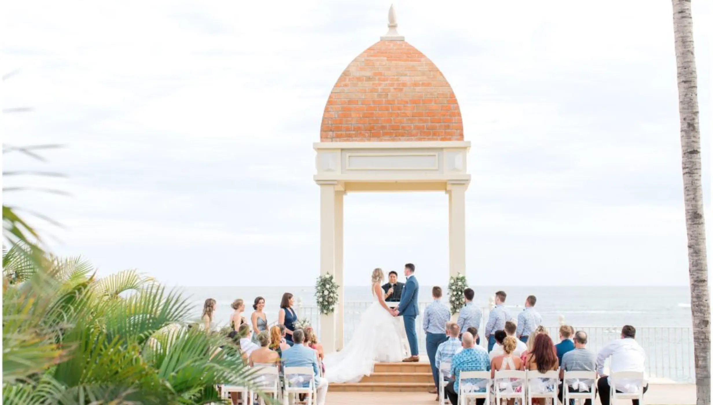 Wedding ceremony under a domed gazebo overlooking the ocean at Riu Palace Cabo San Lucas