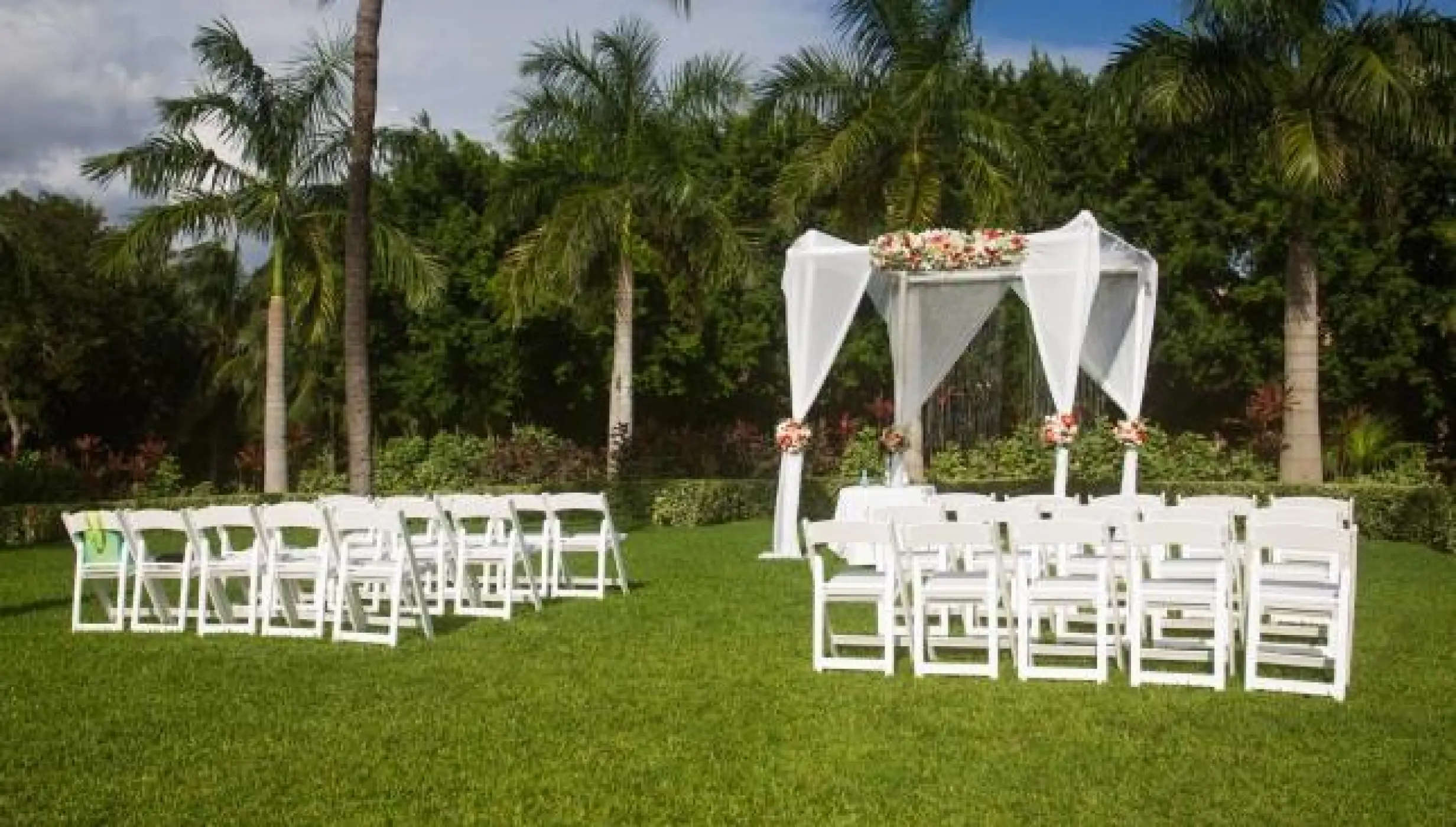 Garden wedding ceremony setup with a white gazebo and palm trees at Riu Palace Mexico, Playa Del Carmen