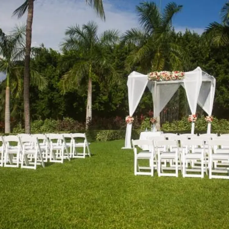 Garden wedding ceremony setup with a white gazebo and palm trees at Riu Palace Mexico, Playa Del Carmen