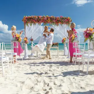 Beach ceremony with the groom lifting the bride at Riu Palace Riviera Maya, Playa Del Carmen